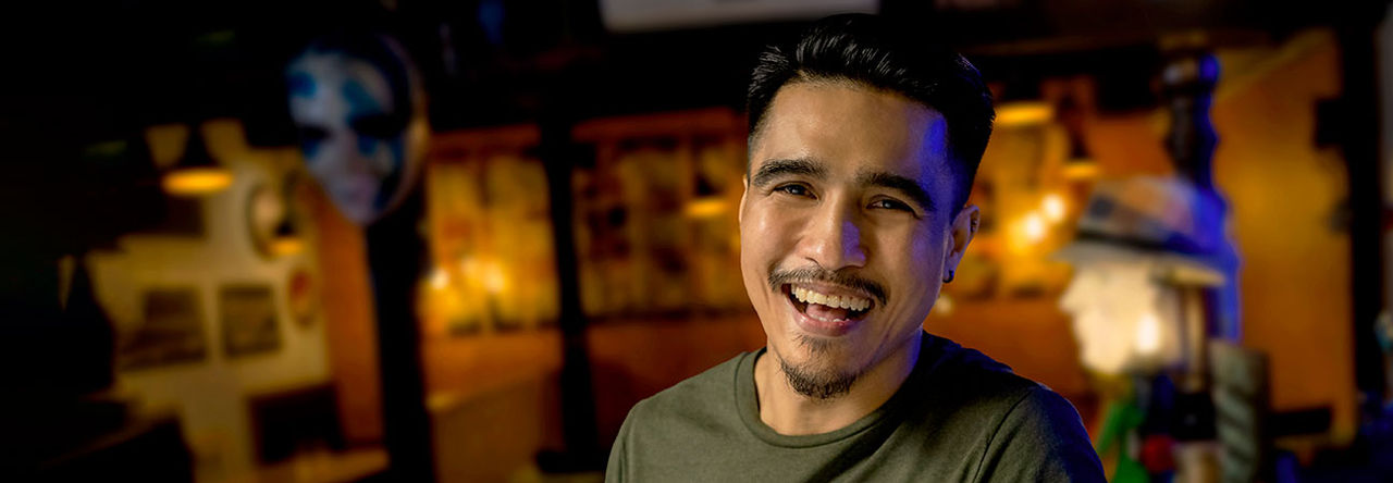 Asian man smiling at camera